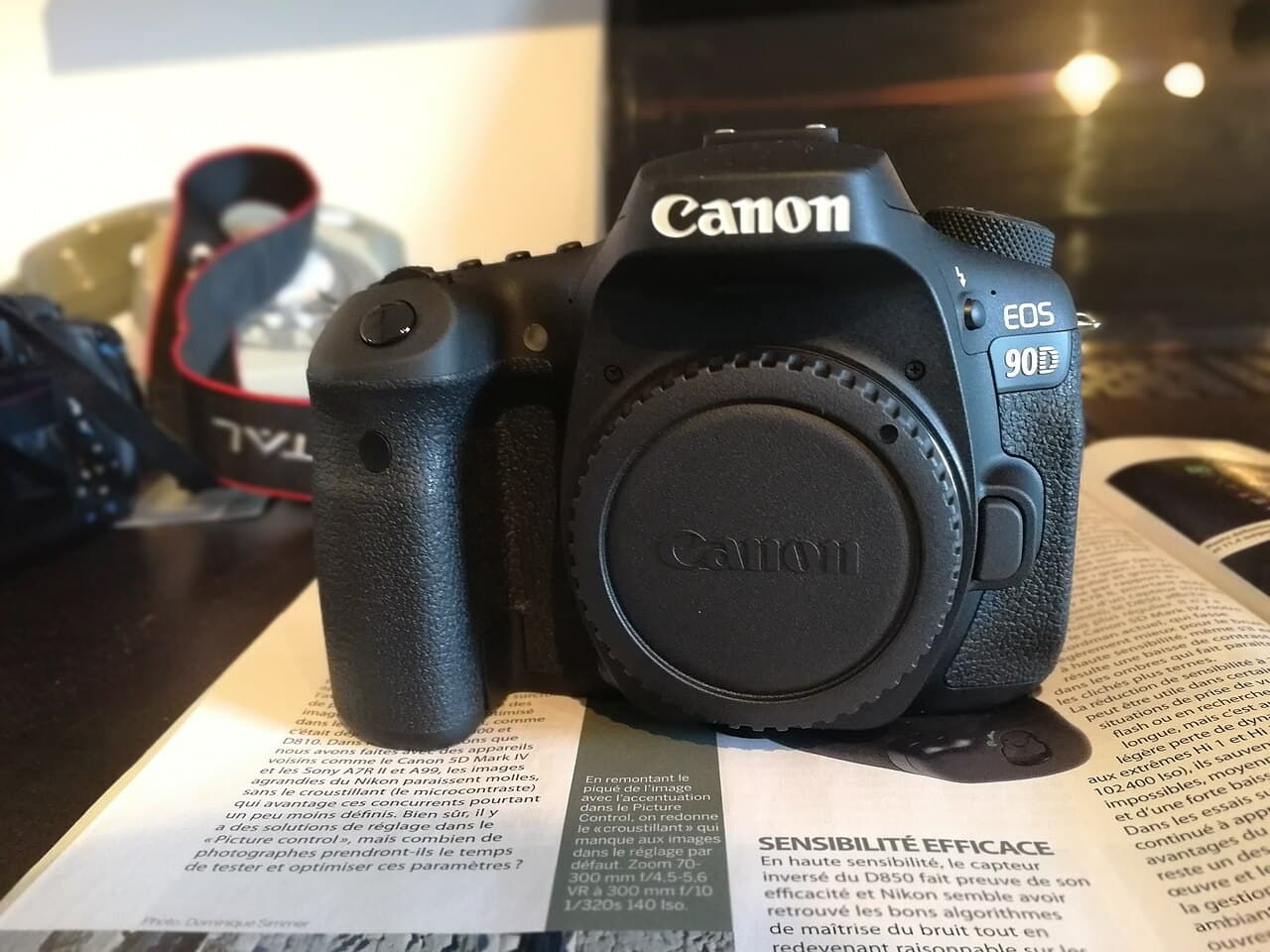 Canon EOS 90D APS-C DSLR camera body, front three-quarter view